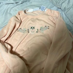 It’s a peach sweater vintage but in good condition